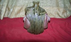 This is a very unique and expressive art pottery jug. It was hand made in Lula, Georgia. The jug measures 7 1/2 inches high and 6 3/4 inches at its widest point and weighs 4 pounds without packaging. It is signed on the bottom: Michael A. Crocker and