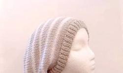 This handmade slouch hat is the colors of linen (tan) and white. Very stretchy, will fit any head, stretches out to 31 inches around. It is knitted in Â½ inch white stripes and 1 inch linen stripes. Available at: http://www.CaboDesigns.etsy.com