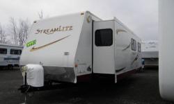 WOW this is a nice one owner camper!! Its very roomy inside. The bedroom and living area both have slide outs, and it has a huge bathroom in the back. The kitchen has a fridge and stove top with a convection microwave underneath. Both the couch and the