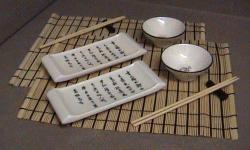 Sushi Set for 2
Includes:
2 black on white dipping dishes (for soy sauce)
2 black on white sushi plates (calligraphy is incised into the surface of the plates)
2 bamboo place mats
2 chopstick rests
2 pr. chopsticks
Simple, elegant look - Perfect condition