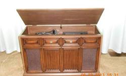 For sale is a Sylvania console stereo system that includes a 33/45/78 speed turntable (phonograph), 8-track player, and AM/FM stereo tuner. A stereo auxiliary input (marked PG4) is also included for connection to a cassette player, iPod, or any other