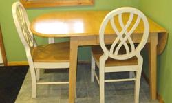 Solid wood table with two chairs. Table is 36"x50", with sides that fold down to 36"x36". Table and chairs are heavy, solid construction and are in very good condition. Please email with questions or for additional photos.