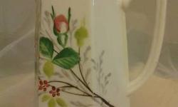 Today I have for you a Tall cream Pitcher. It is paneled around a white background with a floral pattern. The floral pattern is of roses and rosebuds. Very nice detail. It is gold trimmed around the pitcher opening at the top and around the middle of the