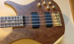 New Lowered Price
Selling this awesome sounding and nice looking Tornado bass, I don't know where
this was made other than is beautifully designed.
It has a nice figured walnut top and also nice sounding pickups configuration and
very cool features also