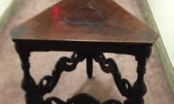 ORNATELY CARVED SOLID MAHOGANY TRIANGULAR TABLE,
PURCHASED IN WEST VILLAGE IN 1950s
17Â¾" X 17 Â¾" X 24Â½" H
BREAK IN TOP FINISH NEEDS REFINISHING AS SHOWN OR PUT ON A BOWL OF FLOWERS. THE REST OF TABLE IN GOOD CONDITION.
$200 cash or best offer.