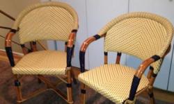 Two French bistro chairs made by Drucker, a high-end French wicker company, and have the highest quality workmanship. These are outdoor chairs but have never been outdoors so are in prime condition; very lightly used. Colors are cream, white, and navy