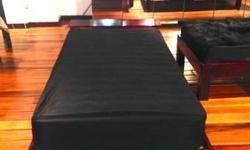 Beautiful, used sleeper sofas in black for sale. Three identical sleeper sofas available for purchase. They each have a solid wood headboard with wooden frames and a supportive twin mattress underneath. The measurements are 40'' wide and 85'' in length.