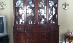 Beautiful 1940's mahogany china cabinet with secretary desk. Measures 79" tall, 65" 1/16 wide, 16" 2/8 deep. Two pieces make moving this solid beauty a lot easier. Very tiny wood chips have broken off of doors and drawer. I have the pieces. Please call or