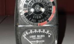 This Light Meter made by General Electric Model # 8DW58Y4 appears to have been made in 1946, It is 3 meters in one: a Photo-Exposure Meter, a Darkroom Meter and a Light Meter. MEASURES APPROX 3 3/4" X 2 1/4"
SHOWS USAGE WEAR..METER WORKS, NEEDLE MOVES