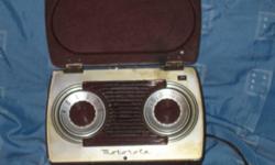 This table/portable lunch box size tube Motorola Radio, Model 5A 7A, circa 1948, is 7 inches wide, 4 inches deep, and almost 5 inches high. Most of the face of the radio is made of bakelite. It has some spotting on the top and rear of the radio. It is