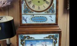 This is a Vintage 8-Day Chiming reproduction of a classic AARON WILLARD Mantel Clock. It is in very good condition less the white background paint at the rear of the glass front panels which is blistering and may be repaired. The lacquered decals of the