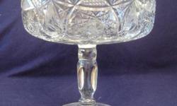 This is a gorgeous antique circa 1920s English large cut crystal fruit bowl on stand. It is in immaculate condition! Just like new! The pictures do not do it justice! It has beautiful cut etchings and stands 7 3/4 inches tall. It makes a spectacular