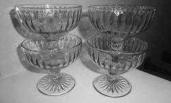 HAZEL ATLAS RIBBON CRYSTAL FOOTED SHERBET CUPS DEPRESSION GLASS SET OF FOUR $20
EXCELLENT CONDITION.
Matching set of 4 vintage dessert cups. 3 in. high 3 1/2 inches diameter at top 2 1/2 inches diameter base of foot. No chips or cracks and design intact.