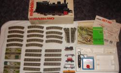 This set is a very hard to find train set by MÃ¤rklin.
It's the HO super deluxe starter train set, I believe from the 70s. Made in WEST Germany.
It has straight tracks, curved tracks, switches, grade crossing and stuff like that.
It has 5 train pieces, the