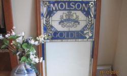 Consider this menu board for your den, or man cave...Molson Golden colored glass menu board. You can write notes or comments on the lower white half with erasable pens. A coat of arms surrounds the word 'CANADA' within the animals. It measures 28.5 " by