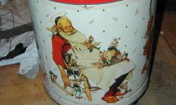 Vintage popcorn tin with 3 Norman Rockwell Santa paintings by "SHUCKS" popcorn company. Circa 1970s? About 10" high. Some wear, good used condition. Jim/9four47nine07