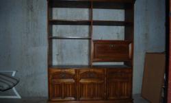 Wall unit / book shelf. Two levels of shelves and an enclosed area for a bar. Bottom is enclosed with a door on each side. See the pictures. Used but in decent condition. Some cosmetic wear particularly along bottom front and bottom corners. Would be
