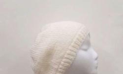 A great beanie for the winter. The color is white. The beanie beret is made with a soft acrylic yarn. Very stretchy, will fit any head, stretches out to 31 inches around. The measurements are lying flat on a table, across the brim or ribbing = 9 inches,