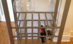 This is a beautiful Wine Bar Stand.
It can hold up to 20 bottles of wine/liquor and up to 16 glasses of wine.
There are 4 shelves to hold the bottles.
Color: TOP SHELVE: GLASS
BOTTOM SHELVES: SILVER
REASON TO SELL: We are moving out of the apartment and