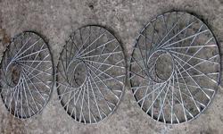 3 deluxe spoke wire wheel covers. These may be from a Cadillac, one was crushed and I dont know if they are supposed to have some kind emblem or badge for the centers. Believe they are spring friction fit for 15" rims, there is a notch in the outer rings