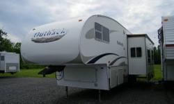 WOW this is a nice fifth wheel!!! The photo's don't do this one justice; the interior is very modern with white cabinetry, which makes it feel huge inside. There is tons of space with the slide out. The best part is this fifth wheel only weighs about