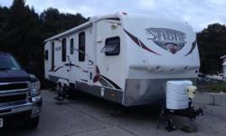 Model no. 31FKDS. Double side outs, electric stabilizer jacks, hide a bed sofa with full air mattress, free standing dinette, satellite tv, residential queen bed, porcelain toilet, corner shower, two HD LCD tv's, flip down bike/utility rack