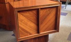 These beautiful cabinets are part of a magnificent bedroom set from the 1970s. Features simple lines and curved base. Would look great in the bedroom or living room as end tables. Well made and in excellent condition. Made in Canada of walnut wood. No