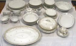 Set is in perfect condition; no chips or scratches. Set includes plates, dessert plates, soup bowls, coffee cups and saucers, sugar bowl and creamer, gravy boat and 1 large serving bowl. Shown is one of each piece in set.
