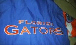 "Florida Gators" Winter Jacket.
Men's size Medium
Zip on/off hood.
100% nylon shell, 100% nylon lining, 100% polyester interfill.
Jacket has been treated with Teflon fabric protector against water and stains.
Machine washable and dryable.
Blue with orange