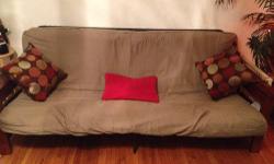 We are selling our futon couch. It is in good condition - no stains or rips. We are getting new furniture and would like to sell it within the next week to two weeks. It has wooden side frames with magazine rack and arm rests that open with storage.