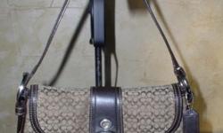 This purse is in very nice condition. I think this bag is the Small Signature Soho Hobo Shoulder Bag and the color is called Khaki/Mahogany. There is a sewn in Coach patch that says:
No F0749-F10925. This is the model that was sold through the Coach