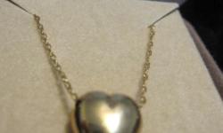 gold-tone heart on 14k gold chain in original box. The chain is 18" and has a round clasp. The heart is approximately 1mm by 1mm. It is in excellent condition.