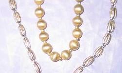 GOLD tone or SILVER tone beaded NECKLACES: Gold is burnished round beads on threaded on chain with 41 beads measuring 21". Dull gold, not flashy but elegant and lovely. $14.
SILVER tone by Monet is 25 silver barrels with marks that look like ears of corn