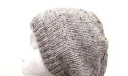 A gray beanie that looks like marble and is a medium gray with tiny flecks of dark brown and light brown worked into the yarn. . The slouchy beanie is made with a soft acrylic yarn.Worn by men, women and teens. Very stretchy, will fit any head, will
