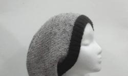This slouchy beanie is medium gray with tiny flecks of black and light brown worked into the yarn. Completely hand knitted. Suitable for men and women. It has a black brim. Very stretchy, will fit any head, will stretch out to 31 inches around. The