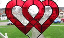Handmade stained glass suncatcher, measuring approximately 6.5" x 8", and edged with lead came for added stability.
To purchase, please visit: https://www.etsy.com/listing/130704071/interlocking-hearts-stained-glass?ref=shop_home_active