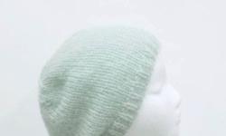 The color of this handmade knit beanie hat is a beautiful pale sea foam color. This beanie beret is made with a soft acrylic, mohair and wool blended yarn. It is described as a soft fuzzy warm hat. The measurements are lying flat on a table are across the