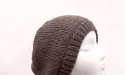 This beanie is a warm beanie in the color of brown. Very stretchy, will fit any head, stretches out to 31 inches around. Completely hand knitted. Worn by men and women. The beanie hat is made with a soft acrylic yarn. (Note: this yarn manufacturer calls