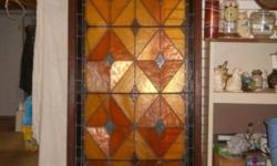This is a large 40" wide x 102" tall stained glass window with a sun ray hinged top piece that opens out to let air in. Could use this top piece by itself, as very pretty.
There are 2 panes that are cracked (BB shot)as shown in pictures and the glass has