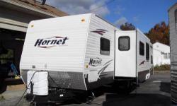This camper is as close to new as you can get at this price!! The front of the camper h as a queen size bed with lots of storage. The rear has four bunks, bathroom with separate entrance, kitchen and table. The kitchen area has a fridge, stove, microwave,