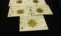Signed Georges Briard raised serving platter (17" by 8") and 3 smaller plates (6" by 8 1/2"). This white and gold tiled set is by an award-winning Mid-Century designer. The backs of all pieces are gold colored metal. There is some discoloration of the