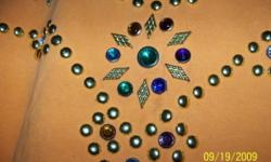 I have a large assortment of nailheads and rhinestones, all colors and sizes
for studding shirts, bags, belts, etc.
Can be sold as a lot charge or small quantities.
Very inexpensive compared to craft store prices. They offer 10-20 stones
in a small bag, I