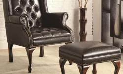 This sophisticated executive office chair will add both style and comfort to your home office. The high curved chair back and seat are covered in rich leather-like vinyl, with exposed wood scroll arms and classic nail head trim accents. An adjustable