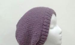 The color of this oversized beanie slouch is a very soft lavender purple called dusty purple . Very stretchy, will fit any head, stretches out to 31 inches around. The measurements are lying flat on a table, across the brim or ribbing = 9 inches, across