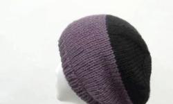 A very unique beanie which is purple with a black crown. The color of this beanie hat is a very soft purple called dusty purple and black . Completely hand knitted. Worn by men and women. The slouch hat is made with a soft acrylic yarn.ery stretchy, will