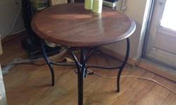 Two round end tables with wood tops and iron legs. $12 each, $20 for both, or make an offer! Must pick up.