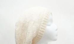 This oversized beanie hat is a winter white (off white) color. It is made with a soft pure wool yarn. It is a medium thickness, very stretchy, will fit any head, will stretch out to 31 inches around. This pattern is called ?tracks?. Fits adult heads.The