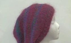 A colorful slouch hat,very confortable. This beautiful hand knitted slouchy beanie hat is a blend of 80% Mohair (magenta) and 20% Cotton yarns (multicolor). A magenta and lavender colors with tiny specks of green, blue, orange, and pink makes this very