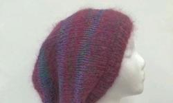 A colorful hand knit slouchy beanie 20% cotton yarns (multicolor). A magenta and lavender colors with tiny specks of green, blue, orange, and pink makes this very unique. This slouchy beanie is fuzzy and soft. Hand knitted. Very fun to wear. One of a