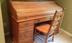 Solid oak roll top desk with two hanging file drawers, four supply drawers, one wide center drawer, four desktop drawers, desktop light, solid oak chair, locking file drawer, and locking roll top. Brass hardware. 72"w x 27"d x 45"h.
This ad was posted